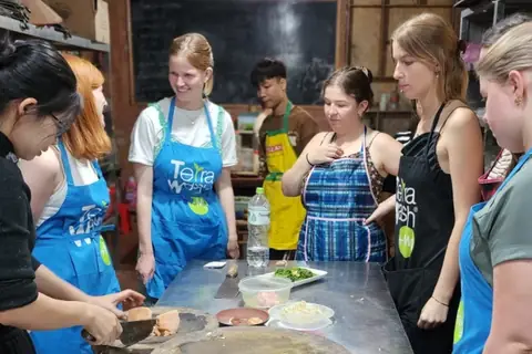 A group of travellers learning to cook with a local host